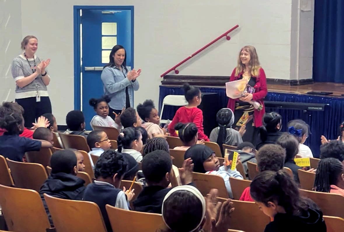 Katya Grineva presents a live concert to a full school auditorium of children